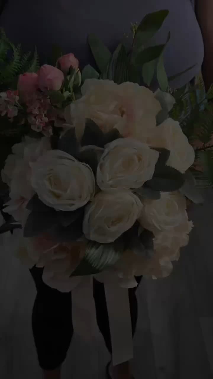 Dense cluster of cream and ivory garden roses