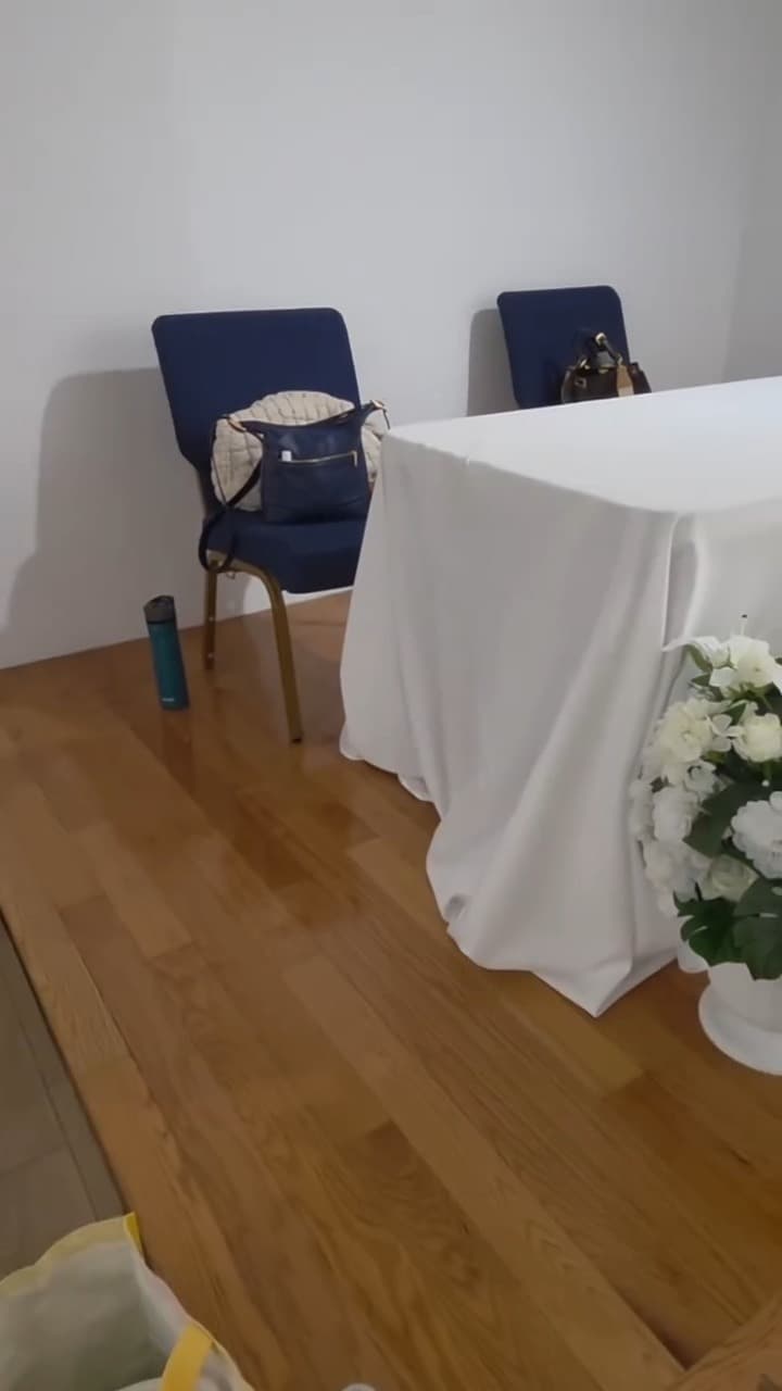 Reception tables dressed in white linen with navy chair sashes